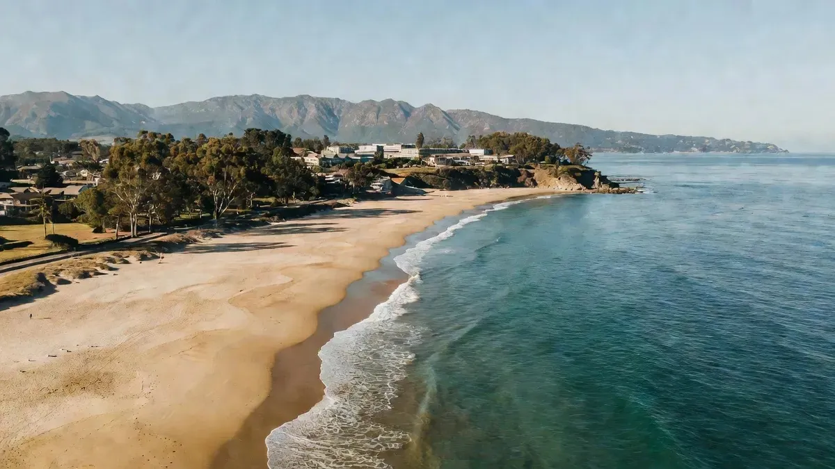 Helicopter flying low along the Santa Barbara coastline with Goleta Beach and the Pacific Ocean visible below on a santa barbara helicopter tour